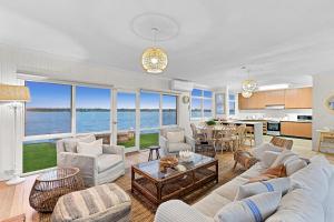 a living room with a view of the ocean at River Meets Ocean Edge - Absolute Waterfront in Barwon Heads +19 photos