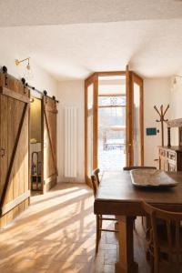 a dining room with a table and a large window at Santocasale in Rocca di Mezzo +46 photos