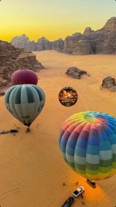 two hot air balloons flying over a desert at MARS MIRROR BUBBLE lUXURY CAMP in Wadi Rum