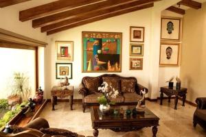 a living room with a couch and a table at BUHO Luxury Guayllabamba Home BBQ Jacuzzi Pool in Quito
