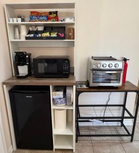 a kitchen counter with a microwave and a microwave at Quiet Naples retreat suite with pool - 1 or 2 bedrooms in Naples