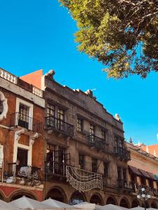 a building with balconies on the side of it at Hotel & hostal Morada in Puebla