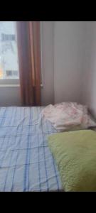 an unmade bed in a bedroom with a window at Pelourinho in Salvador