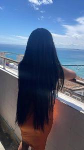 a woman with long black hair looking out at the ocean at Pelourinho in Salvador