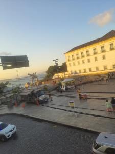 a street with cars parked in front of a building at Pelourinho in Salvador