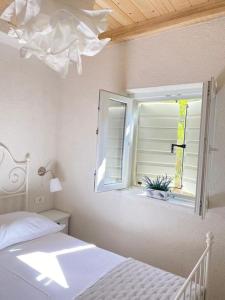 a bedroom with a bed and a window at House Sea la vie in Murter