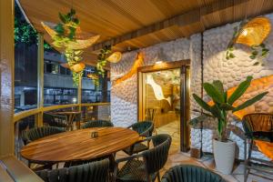 a restaurant with a wooden table and chairs at Leblon Beach Hostel in Rio de Janeiro