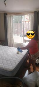 a little girl making a bed in a room at Isabel de la serena in La Serena
