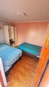 a bedroom with two beds in a room at Isabel de la serena in La Serena