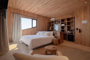 a bedroom with a bed and a television in it at Locus Solus Hotel Singular in Mar del Plata