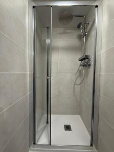 a shower with a glass door in a bathroom at Residence Foemina 65 Val di Luce in Abetone