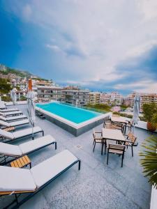 a resort with a pool and lounge chairs and avisorvisor at Perfect location 2 bedrooms Romantic Zone PV 601 in Puerto Vallarta