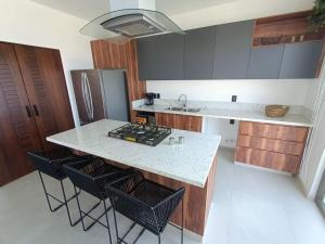 a kitchen with a counter and a island with stools at Perfect location 2 bedrooms Romantic Zone PV 601 in Puerto Vallarta