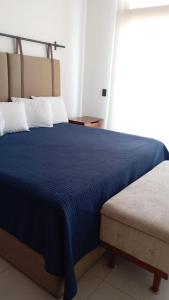 a bedroom with a blue bed and a window at Perfect location 2 bedrooms Romantic Zone PV 601 in Puerto Vallarta +30 photos