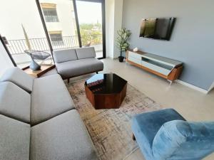 a living room with a couch and a tv at Perfect location 2 bedrooms Romantic Zone PV 601 in Puerto Vallarta