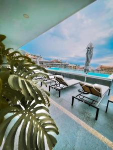 a balcony with lounge chairs and a swimming pool at Perfect location 2 bedrooms Romantic Zone PV 601 in Puerto Vallarta