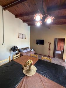 a living room with a table and a couch at Maranatha in Rufino