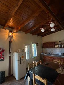 a kitchen with a table and a white refrigerator at Maranatha in Rufino