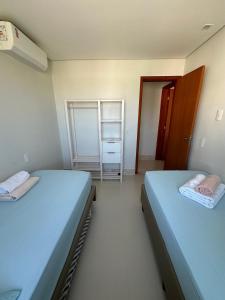 a room with two beds and a closet at Lanzaroti - 204 in Ilhéus