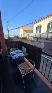a table and two chairs sitting on a balcony at Jardim do Sol in Jardim do Mar +3 photos