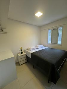 a bedroom with a large bed and a window at Almaré Home in Ubatuba +36 photos