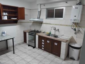 a small kitchen with a sink and a stove at Space in Cochabamba