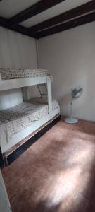a room with two bunk beds and a fan at Apartamento 2 Guazuvira in Guazuvira +4 photos