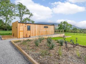 a wooden cabin in the middle of a garden at 1 Bed in Keswick oc-82476 in Bassenthwaite