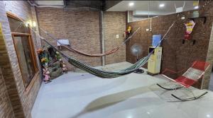 a room with a hammock and two chairs in it at Ximena's House in Iquitos