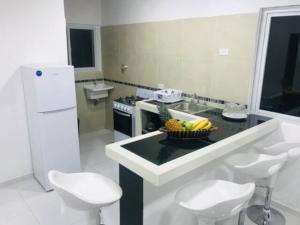 a kitchen with a counter with a bowl of fruit on it at Villa Lourdes in Rousseau