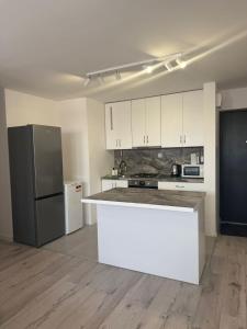 a kitchen with a white counter and a refrigerator at Apartament Centrum nr 8 in Radom