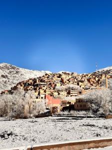 a village in the middle of a snowy mountain at Toubkal home stay in Imlil