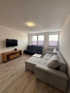a living room with a couch and a flat screen tv at Apartament Centrum nr 8 in Radom