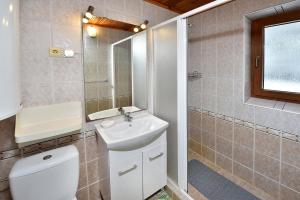 a bathroom with a toilet and a sink and a mirror at Chata Anna Tatranská Štrba in Štrba +33 photos