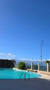 a swimming pool with a view of the ocean at Sol Lazareto Mindelo in Prainha