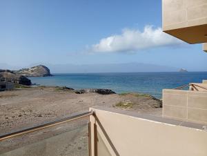 a view of the ocean from the balcony of a house at Sol Lazareto Mindelo in Prainha