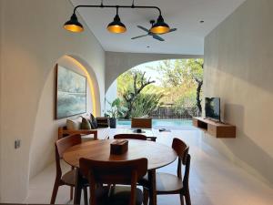 a living room with a wooden table and chairs at Nazeki Villa in Uluwatu