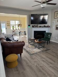 a living room with a couch and a fireplace at The Bee & Bramble in Raeford