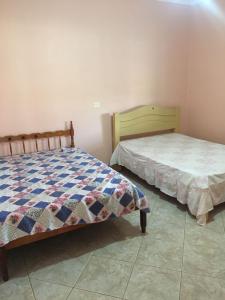 two beds sitting next to each other in a bedroom at Sítio primavera socorro-sp in Socorro +31 photos