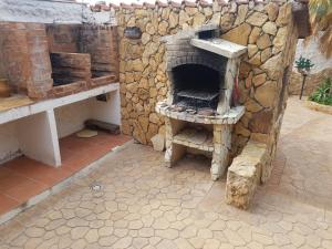 a stone oven sitting next to a stone wall at Residence Villa delle Rose in Lampedusa