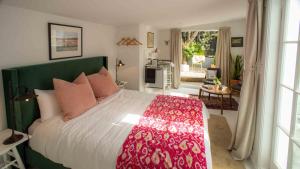 a bedroom with a large bed and a living room at Finnis Studio in Napier