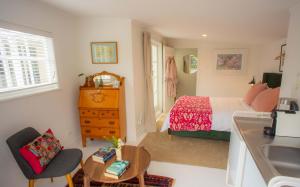 a bathroom with a bed and a sink in a room at Finnis Studio in Napier