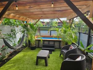 a patio with a hammock and chairs and a pool at Casita Don Marco in Bocas Town