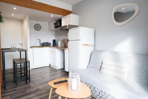 a living room with a couch and a table at Instant Pyrénéen in Lourdes