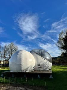 two large domes sitting on a table in a field at Hotel Cielo Stellato in Capitán Pastene +1 photo