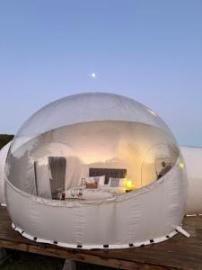a large white dome house sitting on a dock at Hotel Cielo Stellato in Capitán Pastene
