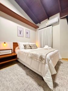 a bedroom with a large bed with a purple ceiling at Pousada Vivenza - Suíte 03 e 04 in Laguna