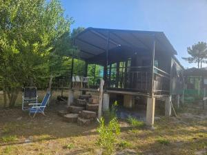 a house with a deck and a staircase in front of it at Mainumbi 1 in Balneario Solís +10 photos
