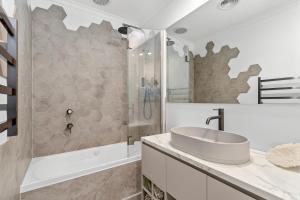 a bathroom with a sink and a shower at Apollo Bay Gone Surfin in Apollo Bay