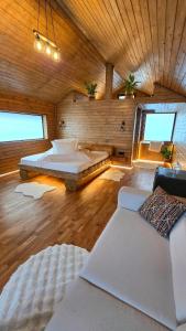 a large room with two beds and a couch at Casuta de la munte in Sărişor